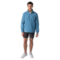 Man wearing a blue jacket and gray shorts on a white background