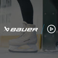 close up on a pair of white ice skates gliding out onto the ice