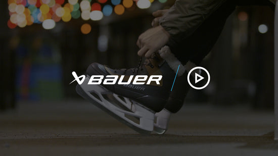 lacing up Bauer Whistler skates next to an outdoor ice rink in NYC